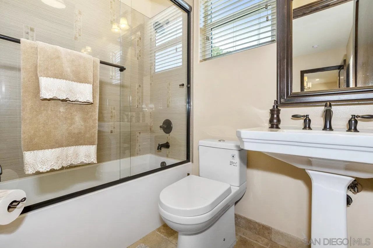 7342 Altiva Place Carlsbad, CA 92009 - Photo 32 of 56 a bathroom with a sink toilet and shower