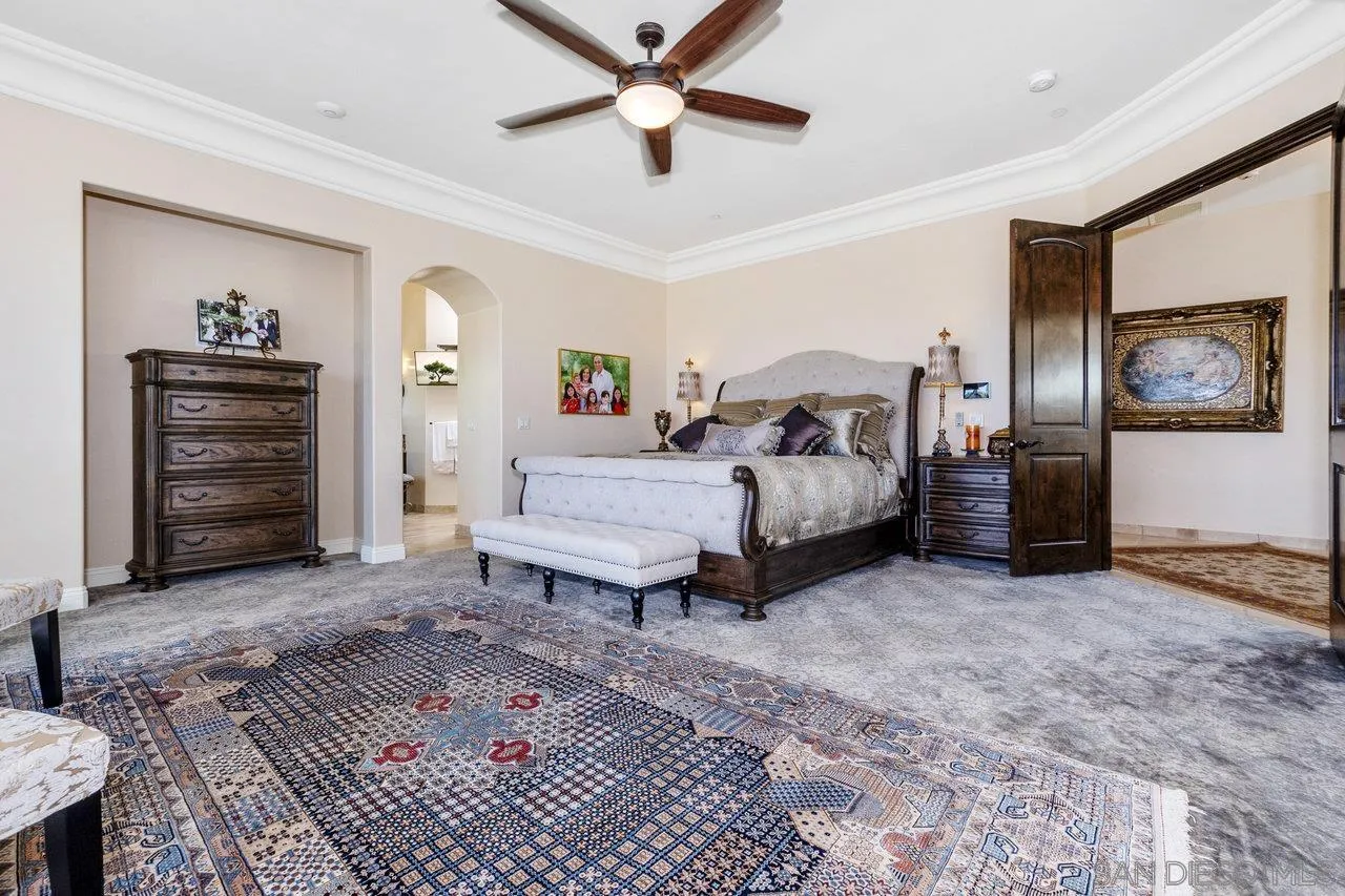 7342 Altiva Place Carlsbad, CA 92009 - Photo 38 of 56 a bedroom with a bed and a chandelier