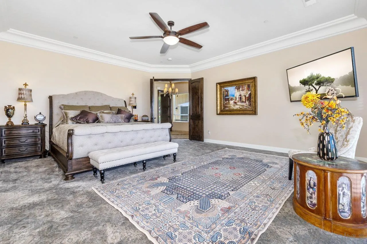 7342 Altiva Place Carlsbad, CA 92009 - Photo 39 of 56 a bedroom with a bed and a chandelier