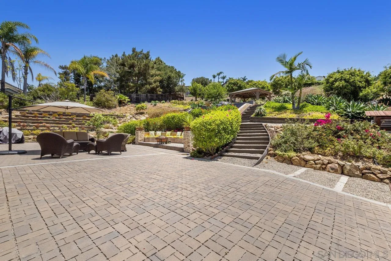 7342 Altiva Place Carlsbad, CA 92009 - Photo 46 of 56 a front view of a house with a yard