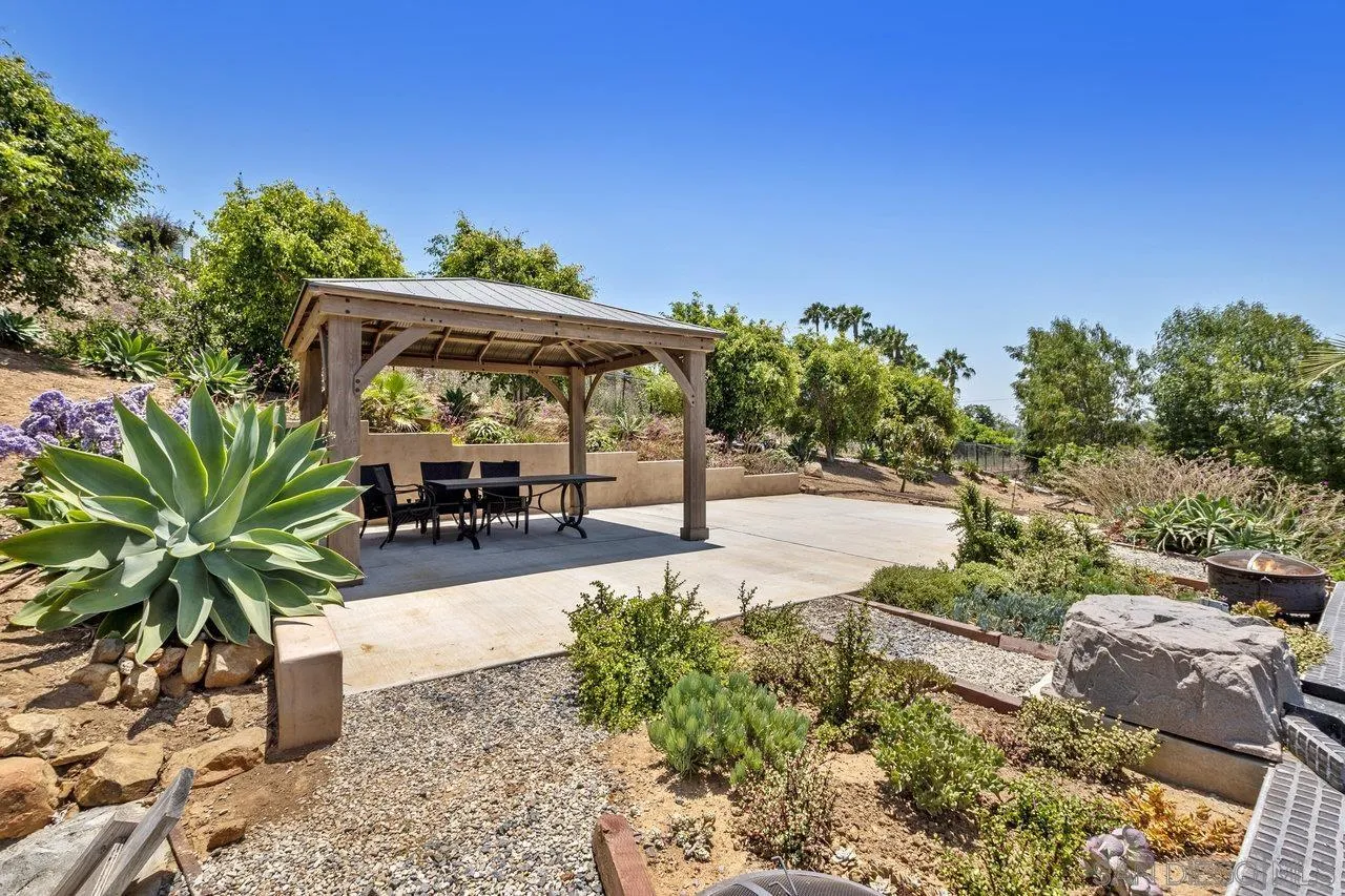 7342 Altiva Place Carlsbad, CA 92009 - Photo 50 of 56 a view of a patio with potted plants and large trees