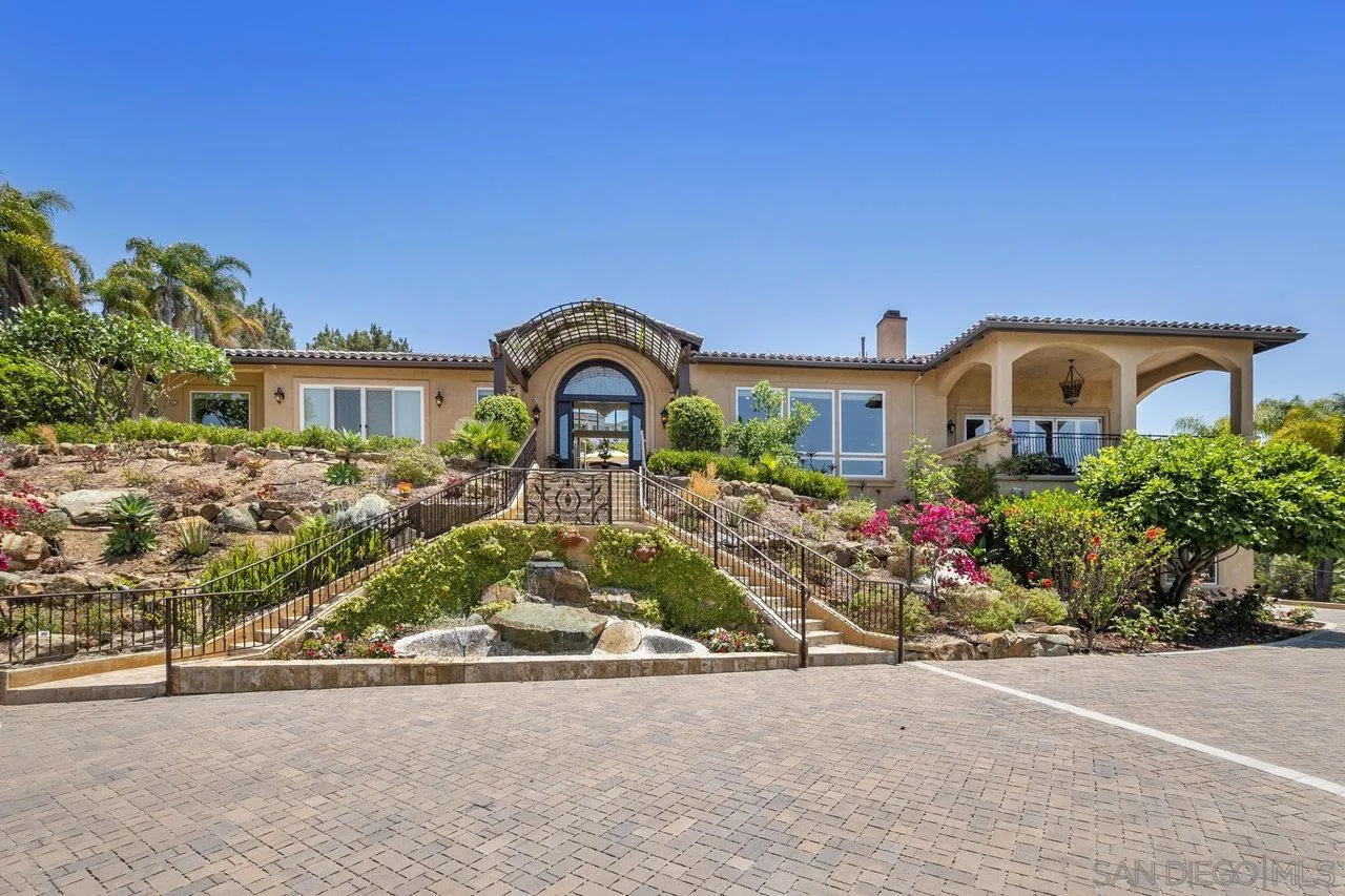 7342 Altiva Place Carlsbad, CA 92009 - Photo 5 of 56 a front view of a house with garden