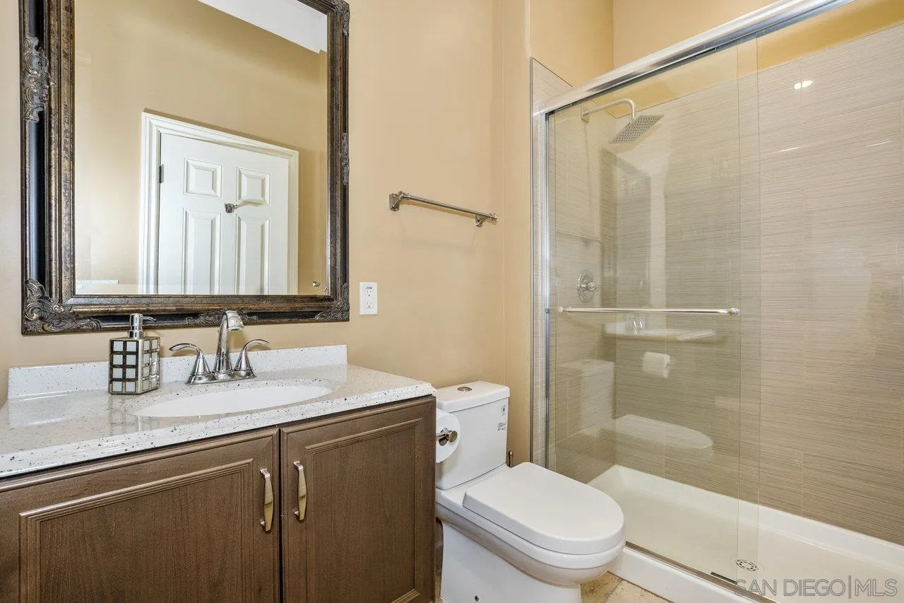 7342 Altiva Place Carlsbad, CA 92009 - Photo 55 of 56 a bathroom with a sink a toilet and shower