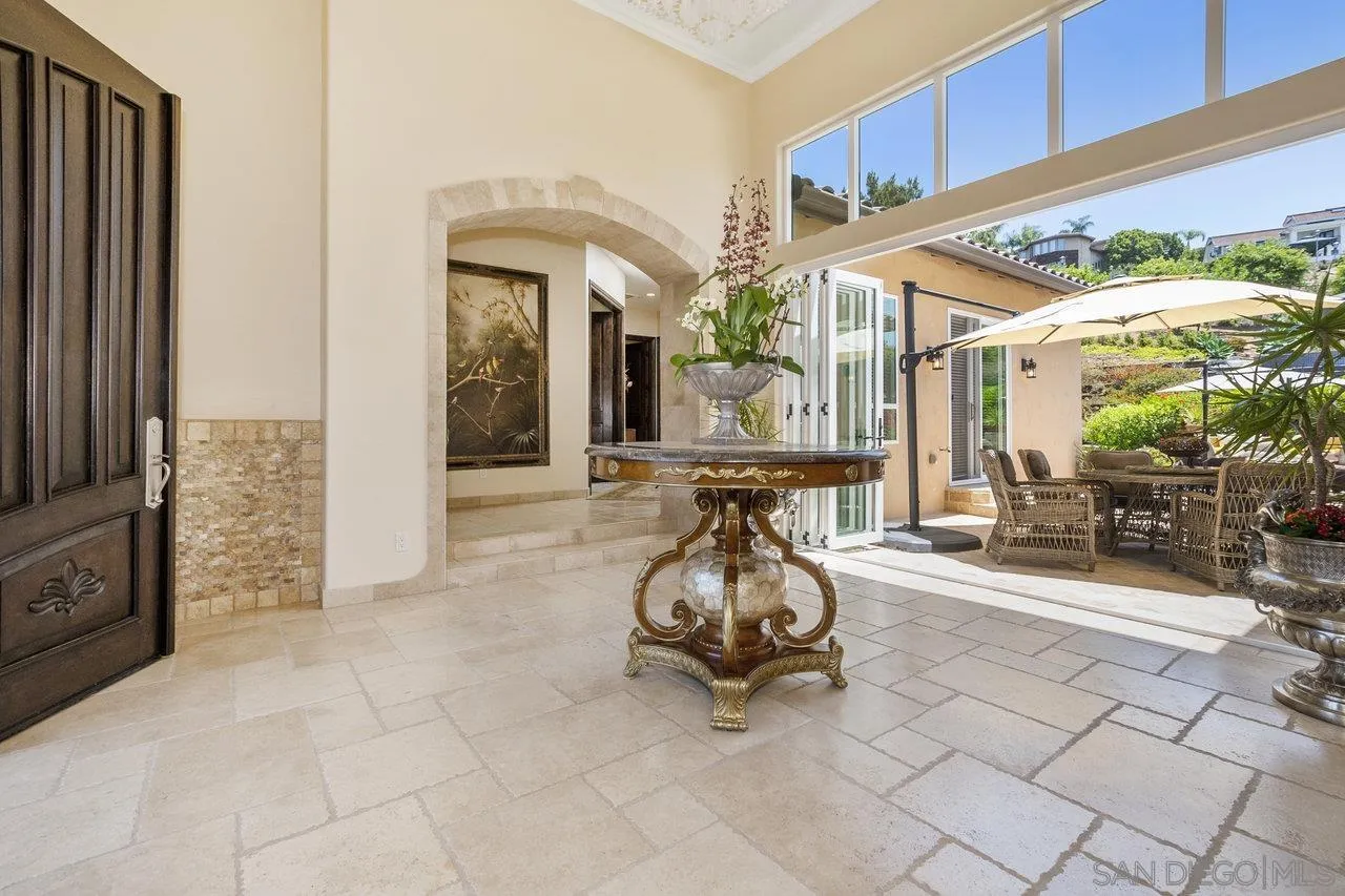 7342 Altiva Place Carlsbad, CA 92009 - Photo 7 of 56 a living room with furniture a flat screen tv and floor to ceiling window