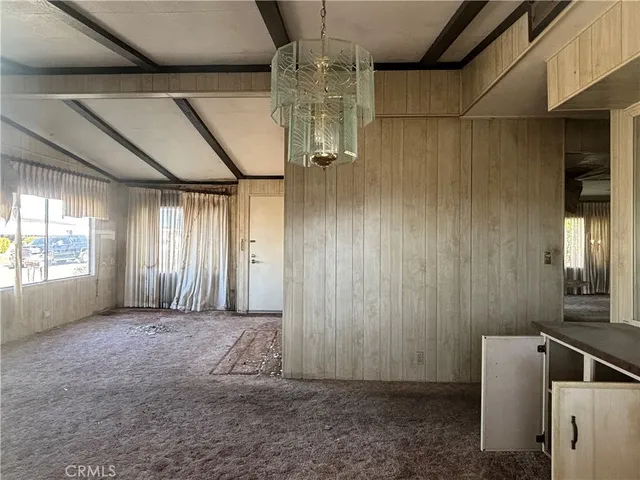 a view of a room with a fireplace and windows