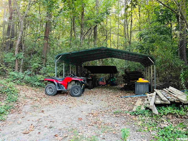 a backyard of a house with table and chairs