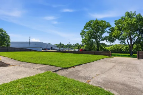a view of a park and trees in the background