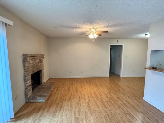 wooden floor in an empty room with a fireplace