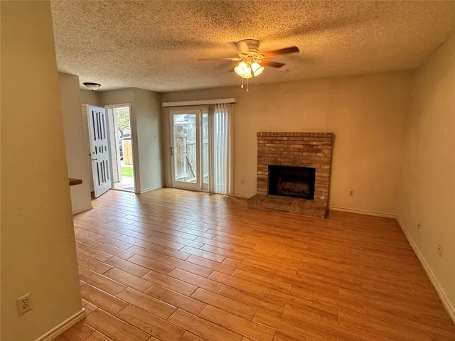 wooden floor fireplace and natural light in room