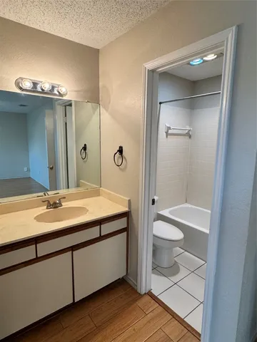 a bathroom with a double vanity sink toilet and shower