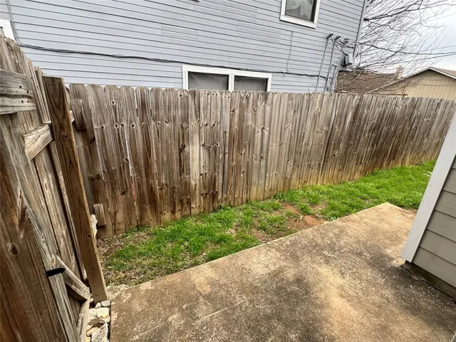 a view of a backyard with wooden fence