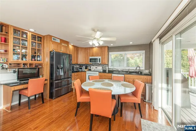 a living room with fireplace furniture and a large window