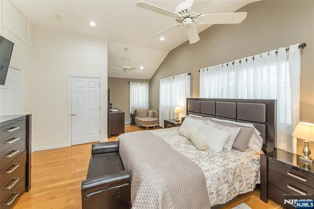 a spacious bathroom with a bathtub shower sink mirror and toilet