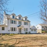 a front view of a building with a garden