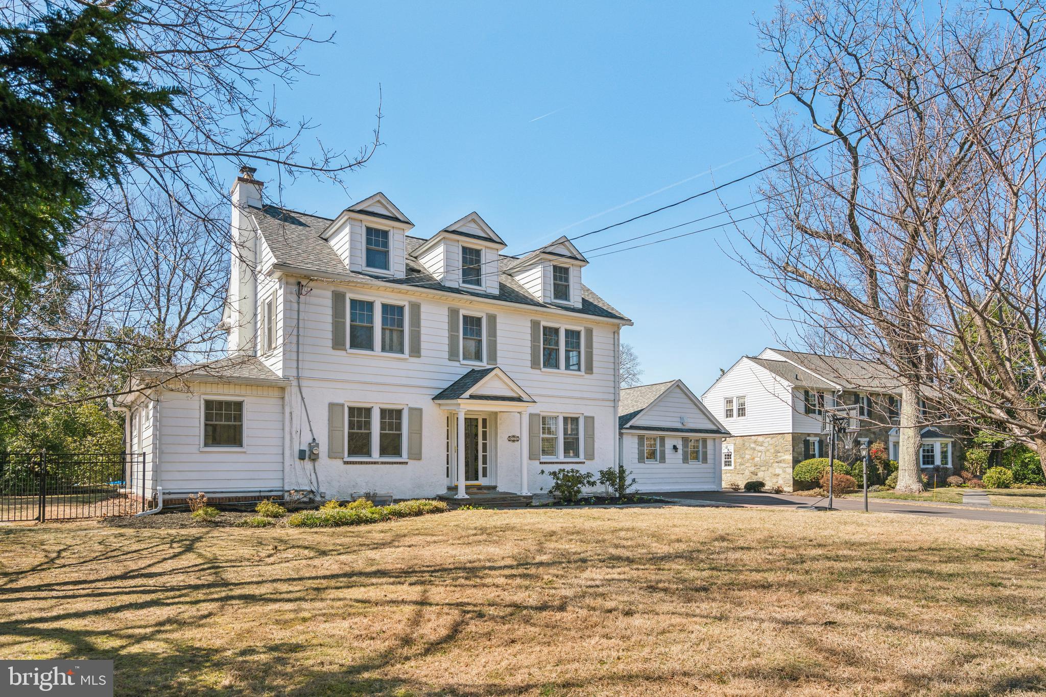 a front view of a building with a garden