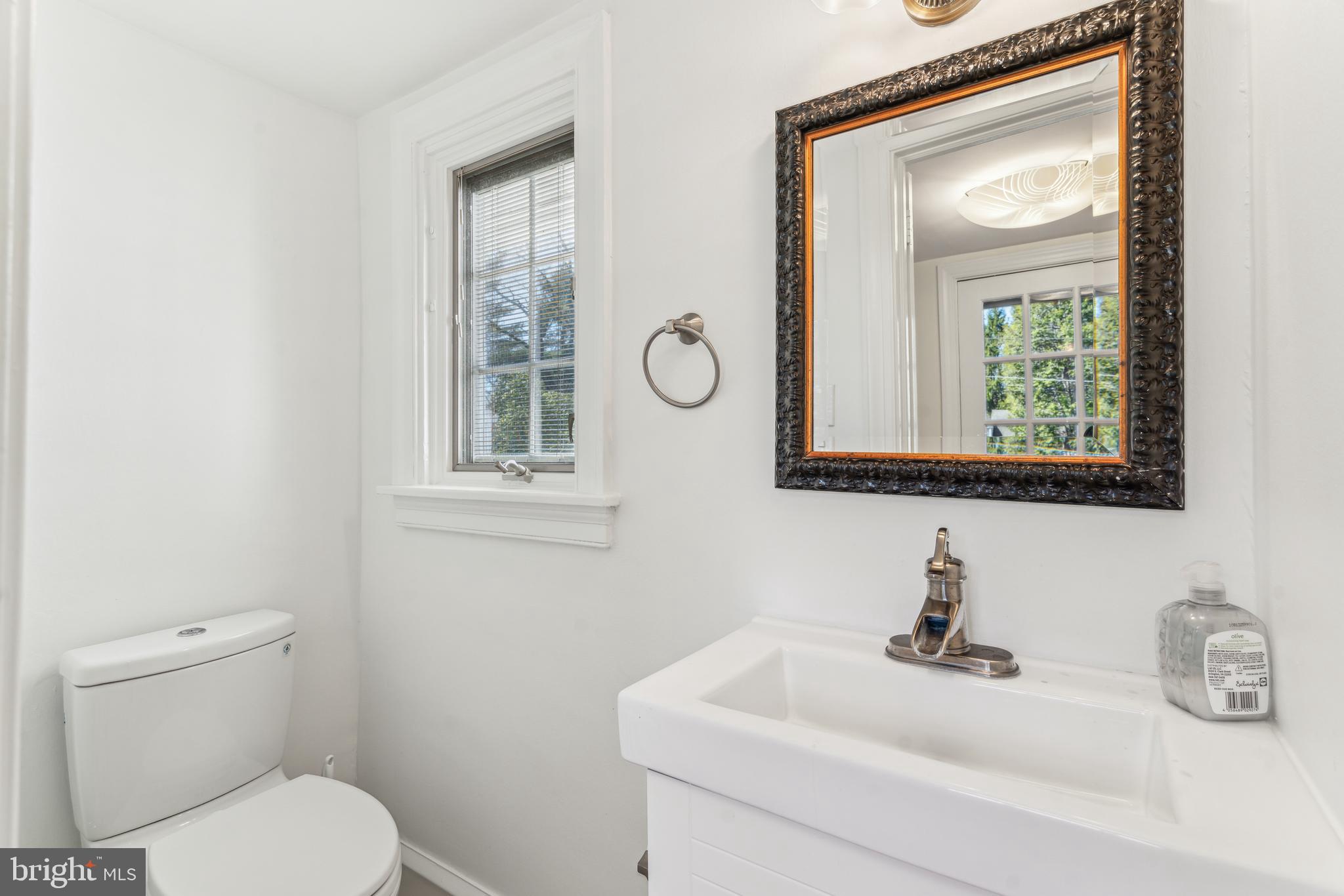 436 Penn Valley Road Penn Valley, PA 19072 - Photo 21 of 64 a bathroom with a toilet sink and mirror