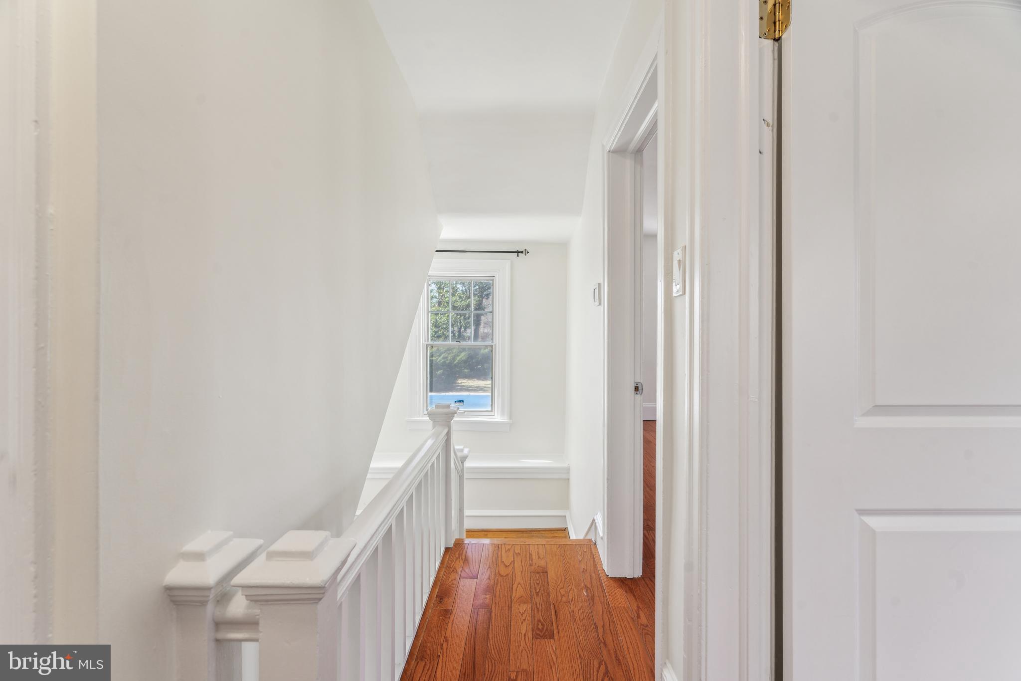 436 Penn Valley Road Penn Valley, PA 19072 - Photo 31 of 64 a view of a hallway with wooden floor and a bathroom