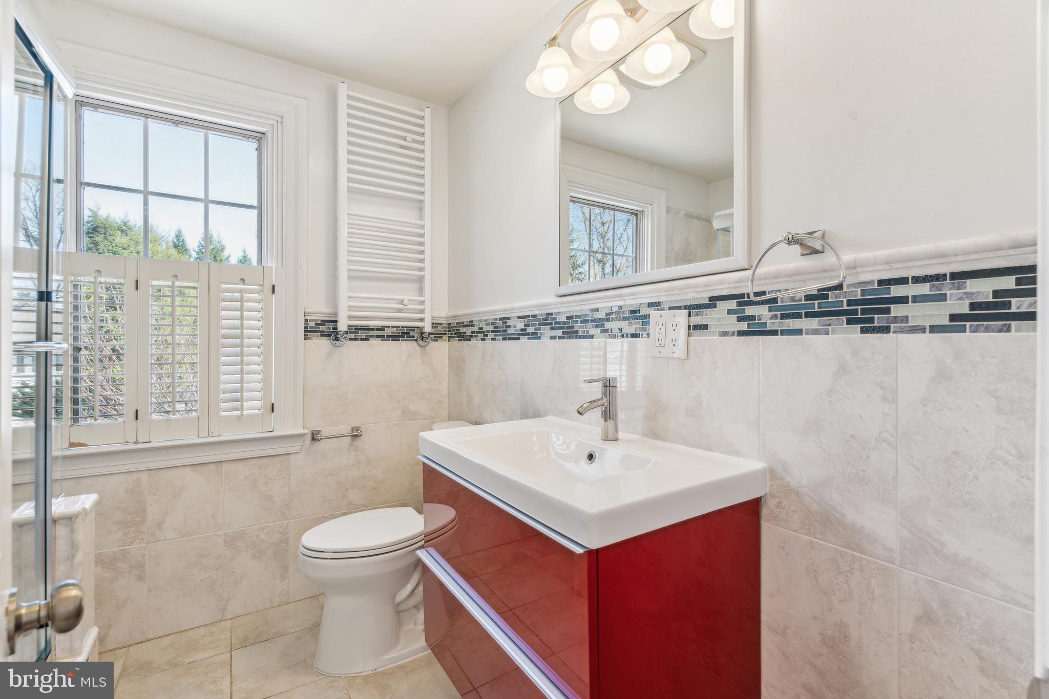 436 Penn Valley Road Penn Valley, PA 19072 - Photo 44 of 64 a bathroom with a sink a toilet and a large mirror