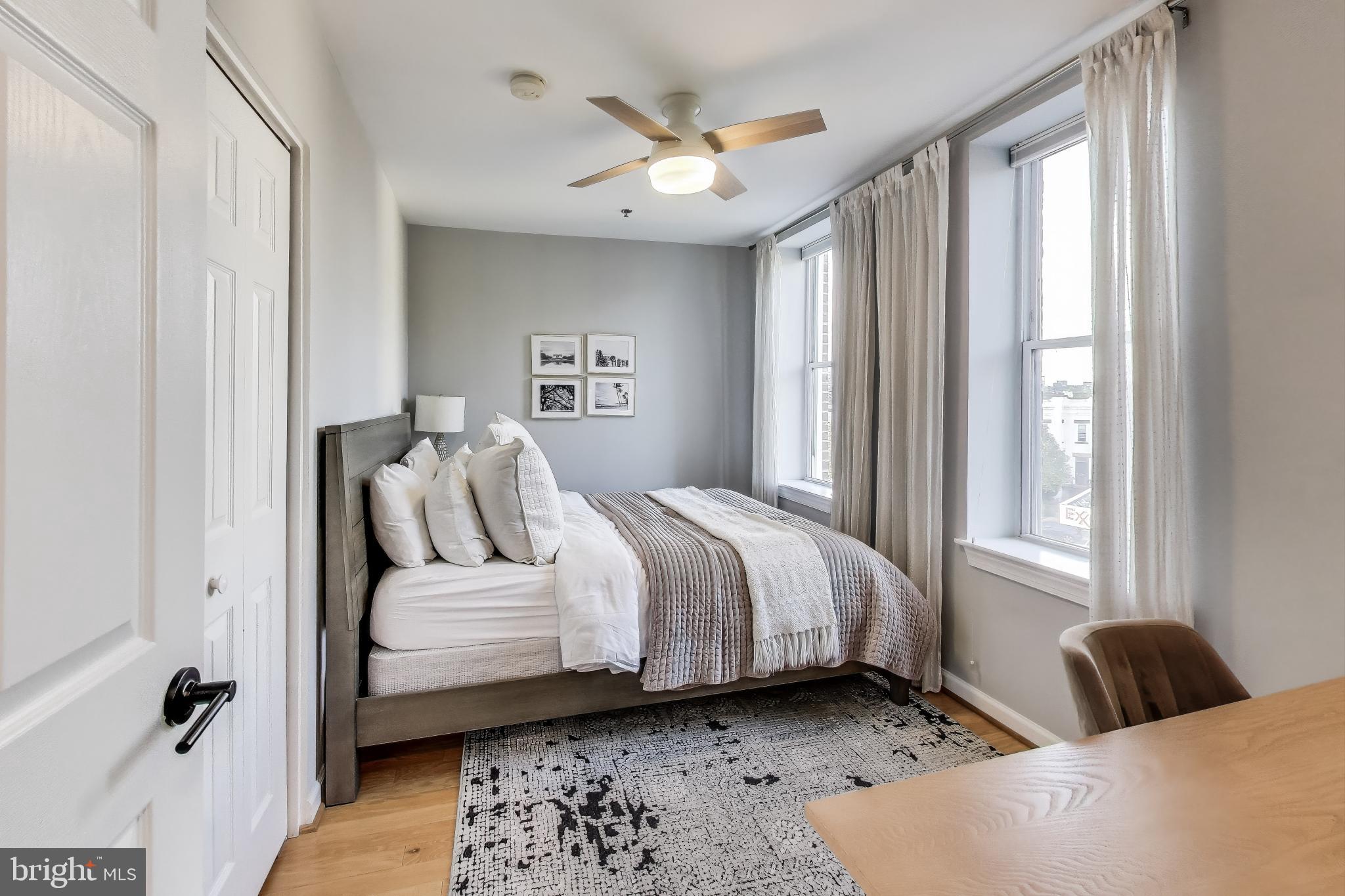 52 Quincy Place Northwest, Unit 304 Washington, DC 20001 - Photo 12 of 22 a bedroom with a bed and a window