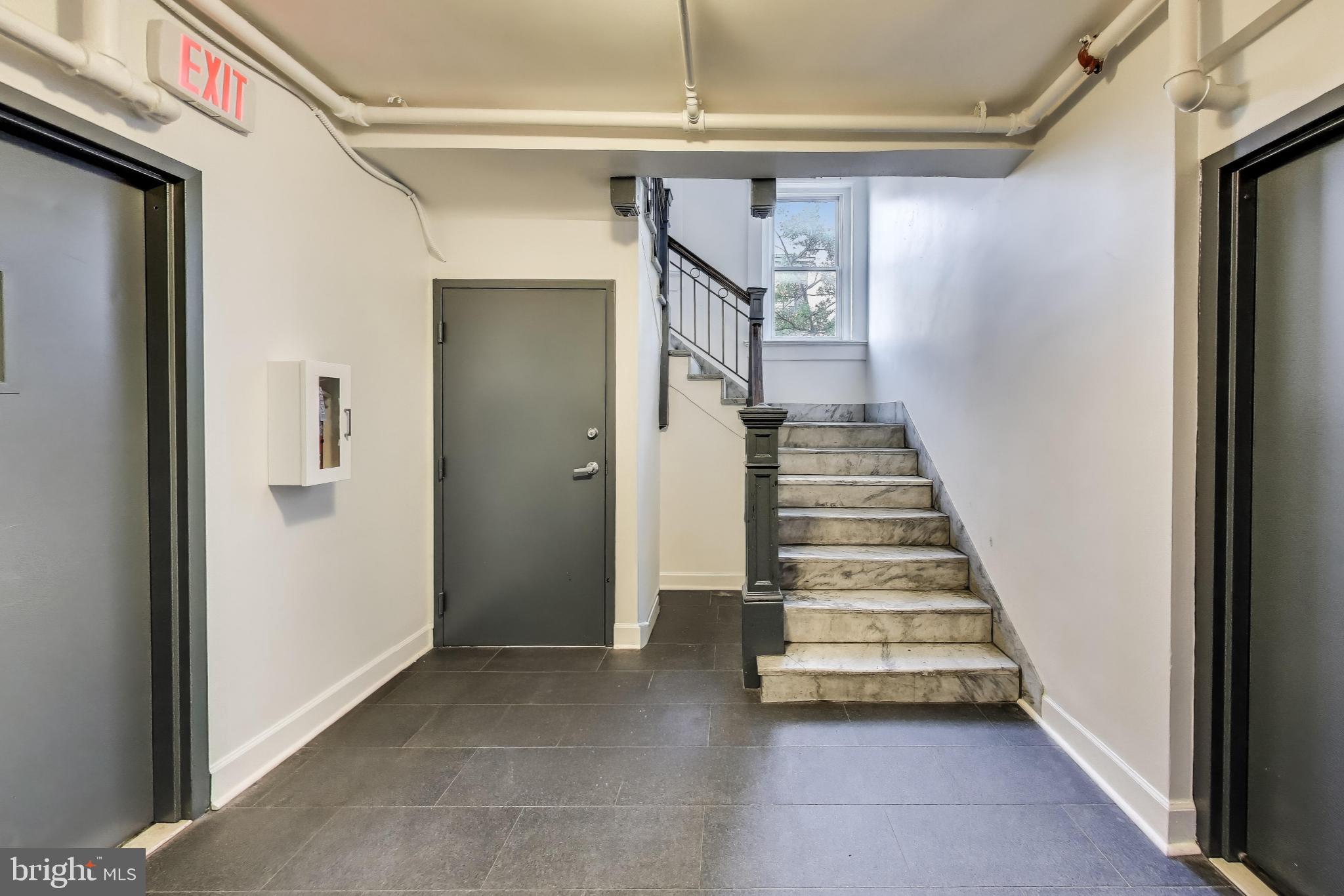 52 Quincy Place Northwest, Unit 304 Washington, DC 20001 - Photo 18 of 22 a view of a hallway with entryway and stairs