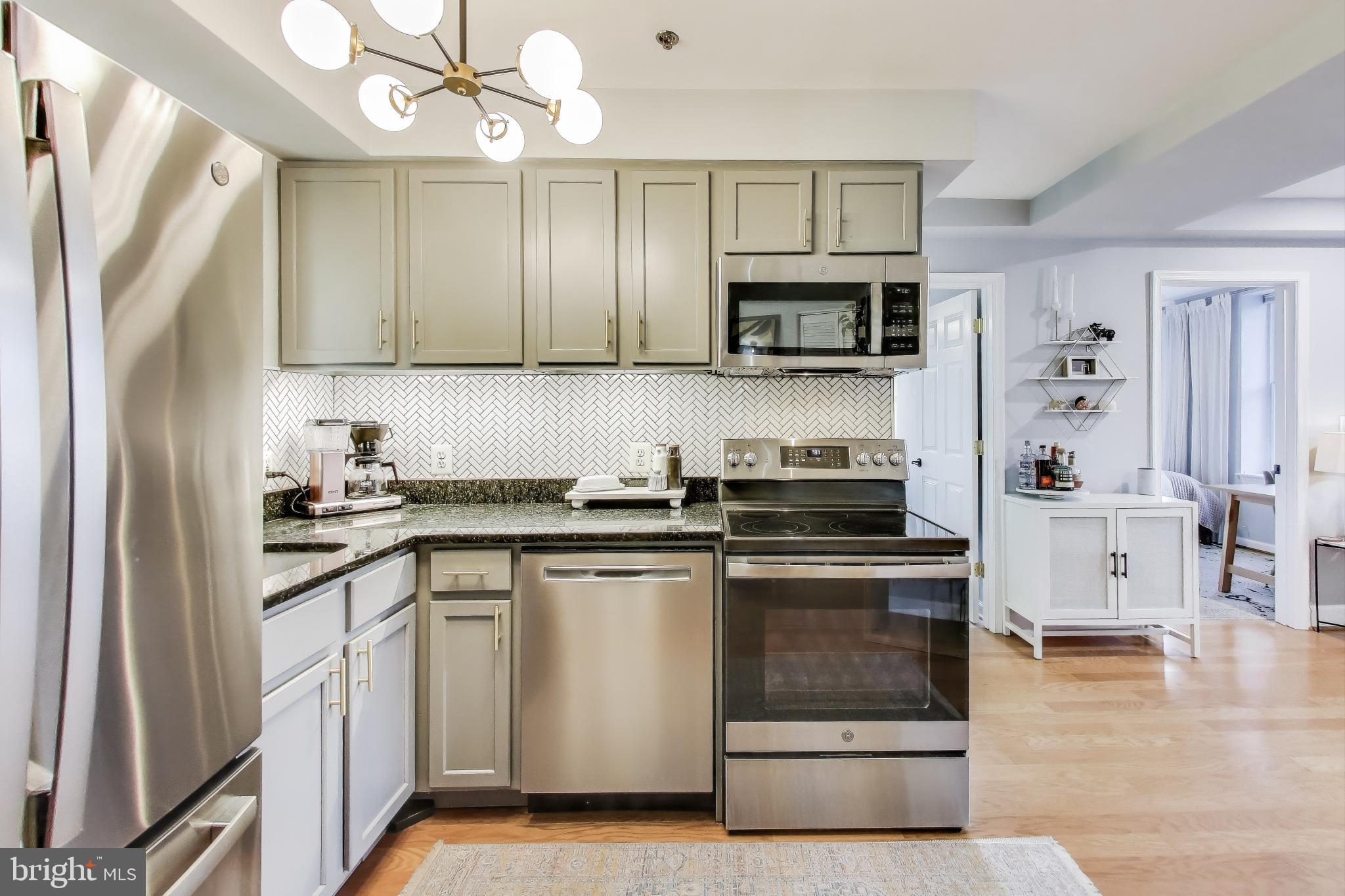 52 Quincy Place Northwest, Unit 304 Washington, DC 20001 - Photo 6 of 22 a kitchen with stainless steel appliances granite countertop a stove a sink and a refrigerator