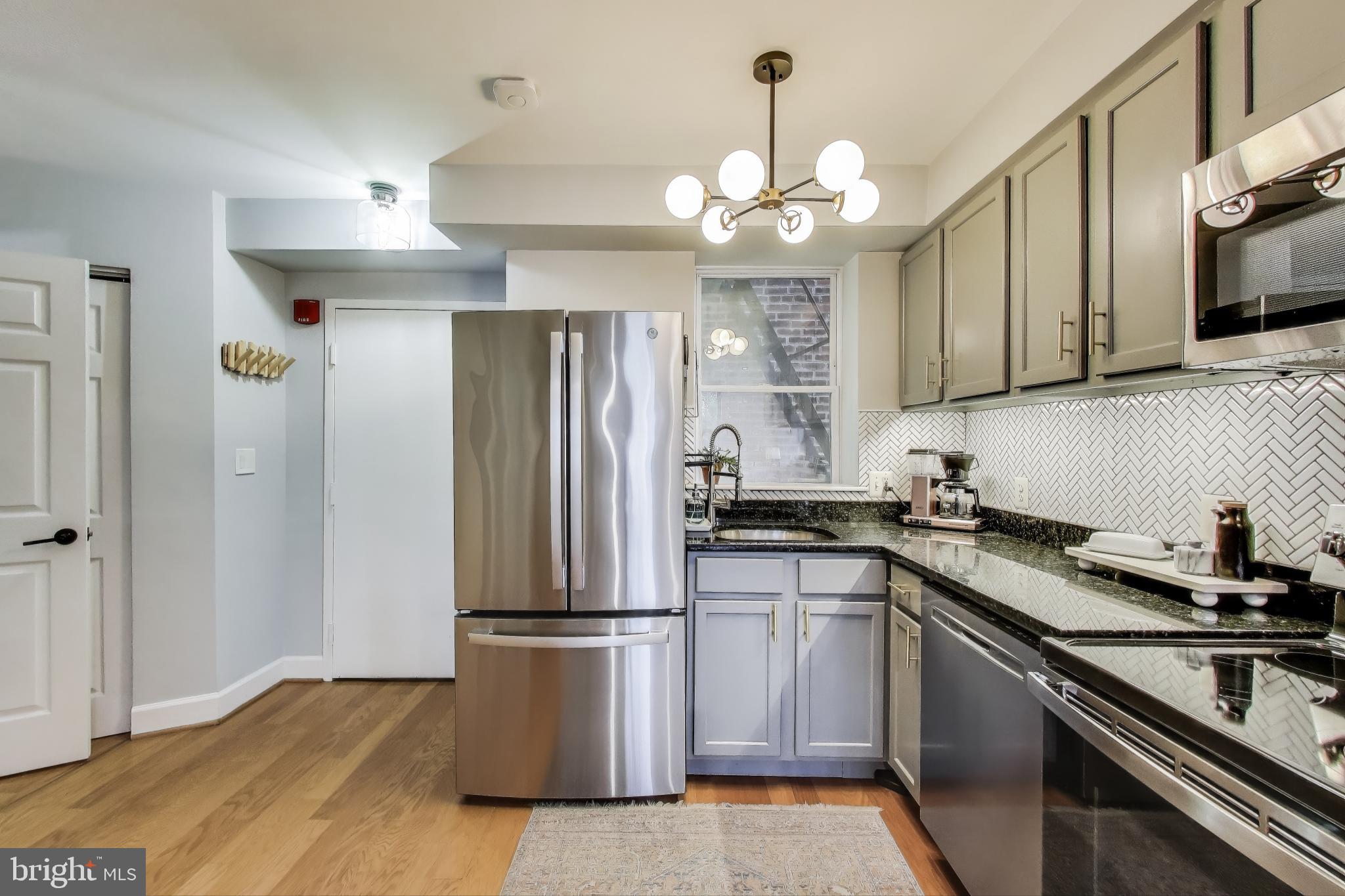 52 Quincy Place Northwest, Unit 304 Washington, DC 20001 - Photo 7 of 22 a kitchen with stainless steel appliances a sink stove and refrigerator