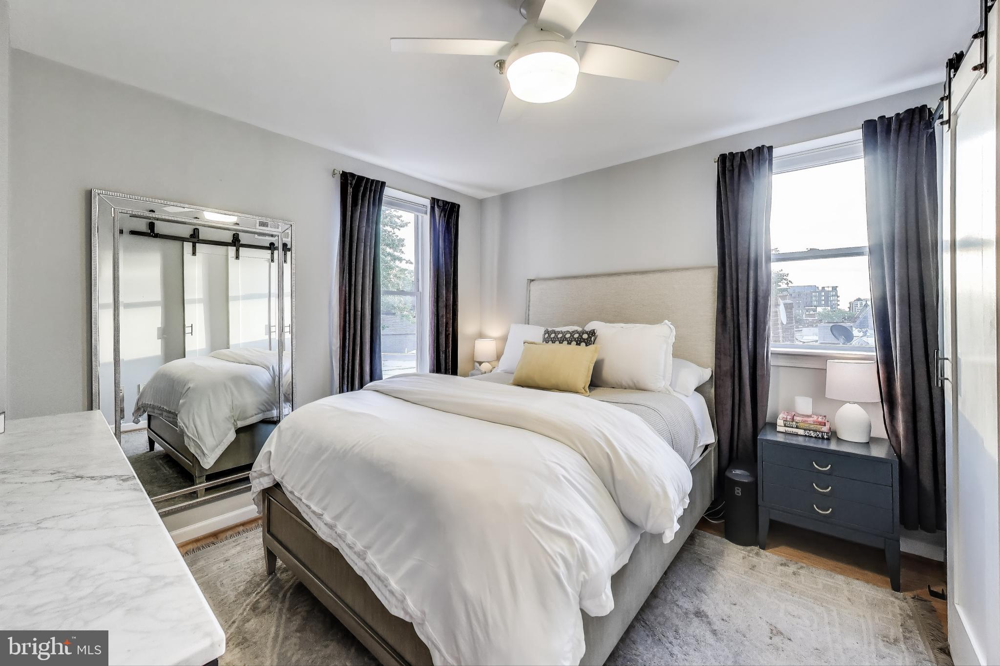 52 Quincy Place Northwest, Unit 304 Washington, DC 20001 - Photo 8 of 22 a bedroom with a bed wooden floor and window