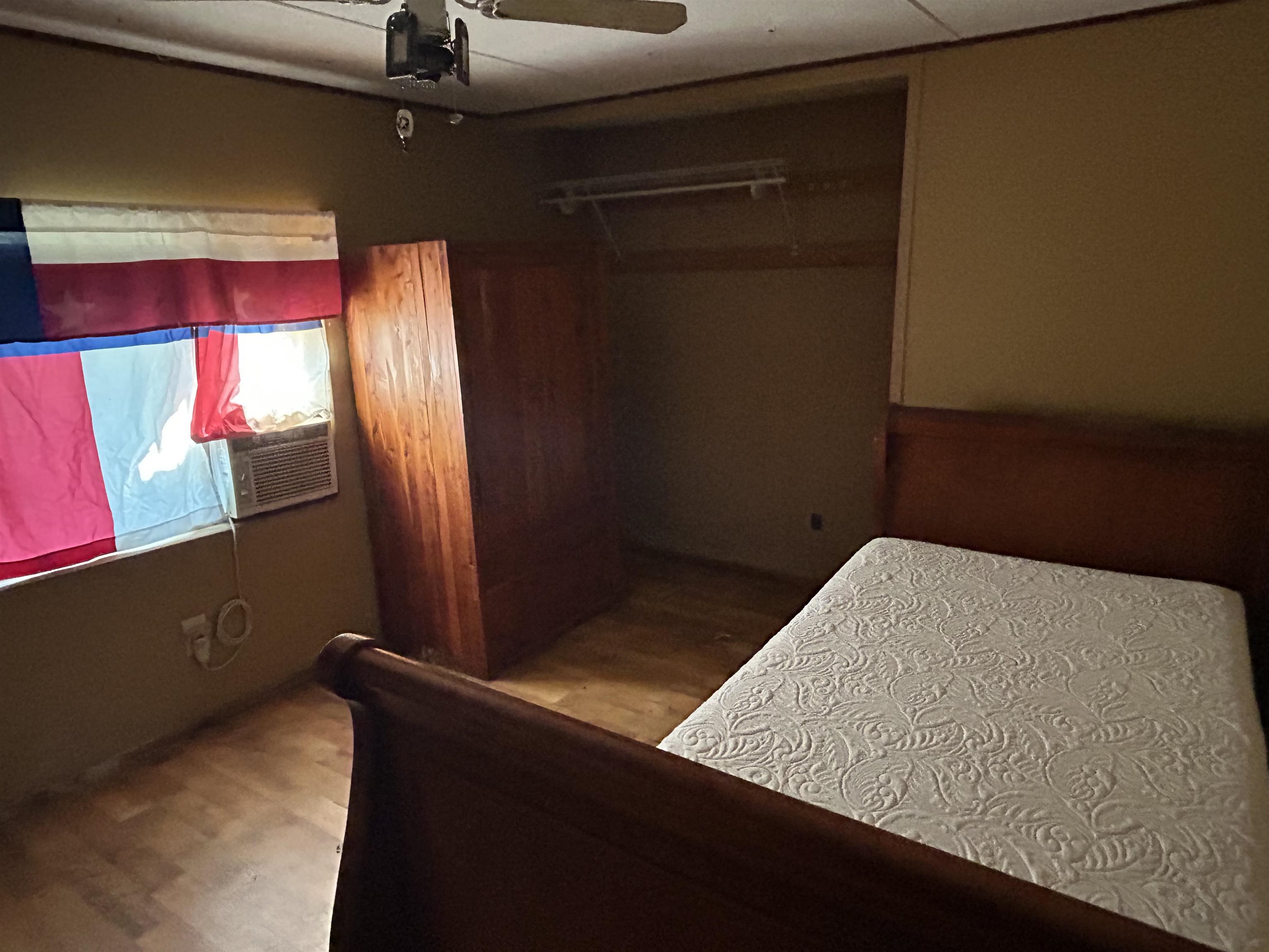 809 West Llano Street Llano, TX 78643 - Photo 11 of 12 a bed sitting in a bedroom next to a window