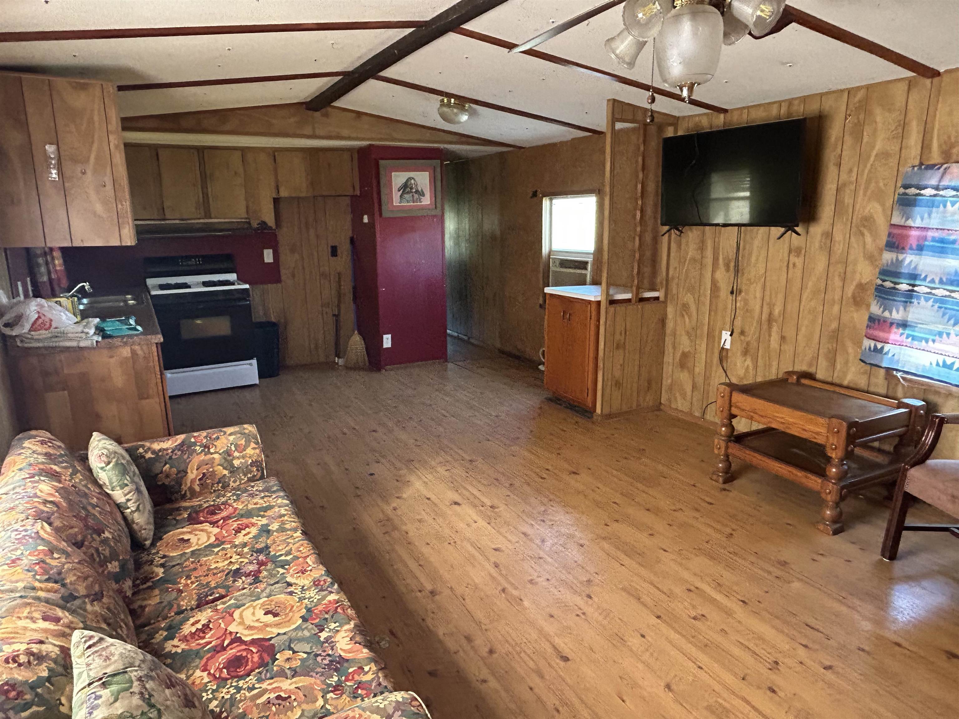809 West Llano Street Llano, TX 78643 - Photo 12 of 12 a living room with furniture and a flat screen tv