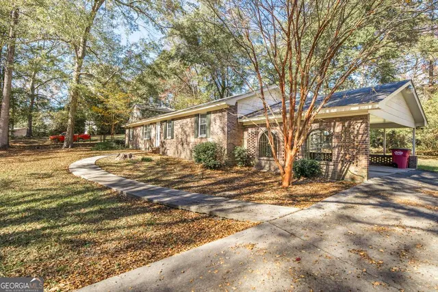 a view of empty room with wooden floor and windows