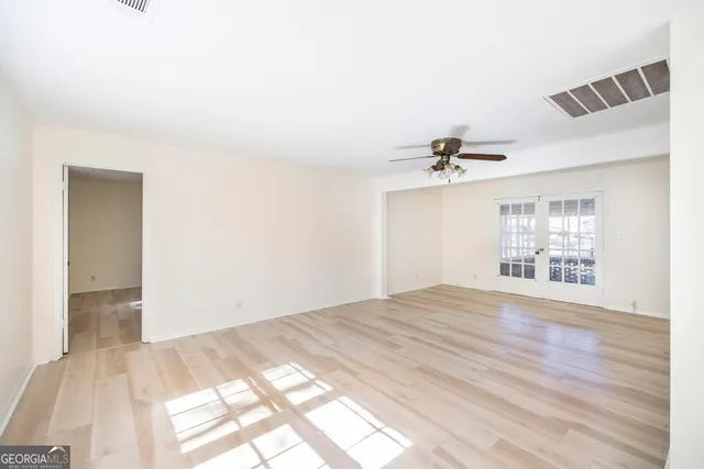 a kitchen with granite countertop white cabinets and black appliances