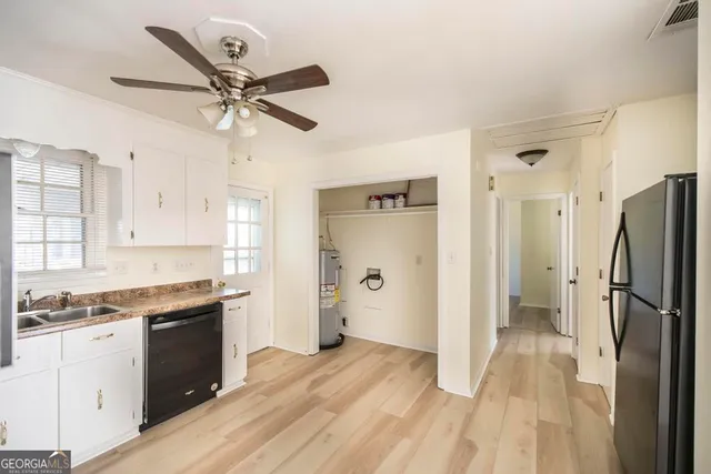 a bathroom with a toilet sink a mirror and vanity