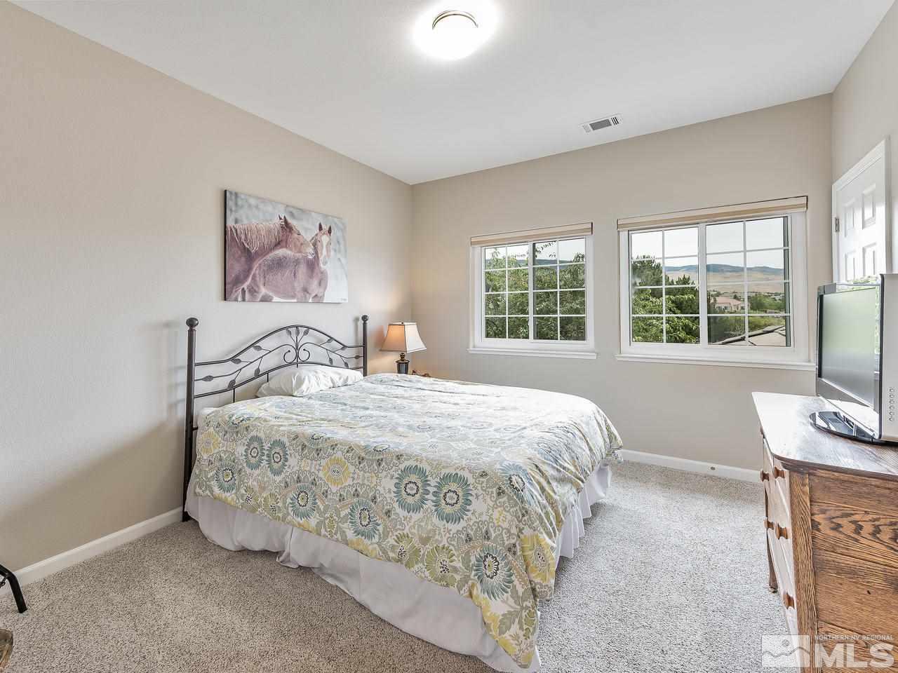 5070 West Albuquerque Road Reno, NV 89511 - Photo 20 of 25 a bedroom with a bed and a window
