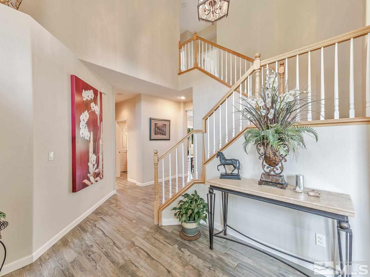 5070 West Albuquerque Road Reno, NV 89511 - Photo 3 of 25 a view of staircase with lots of frames on wall and wooden floor