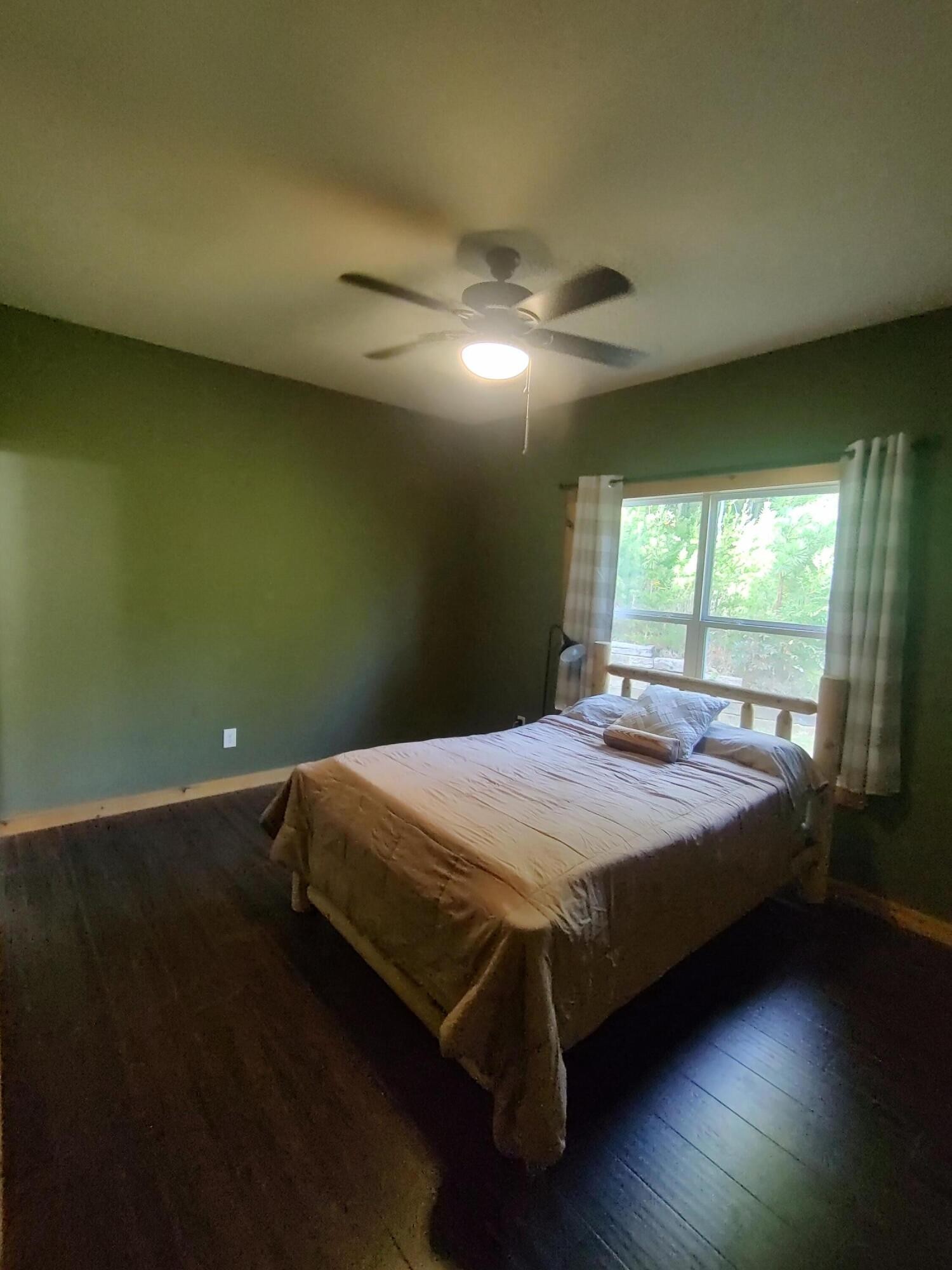 121 Polly Wally Road Ocoee, TN 37361 - Photo 15 of 29 a bed sitting in a bedroom next to a window