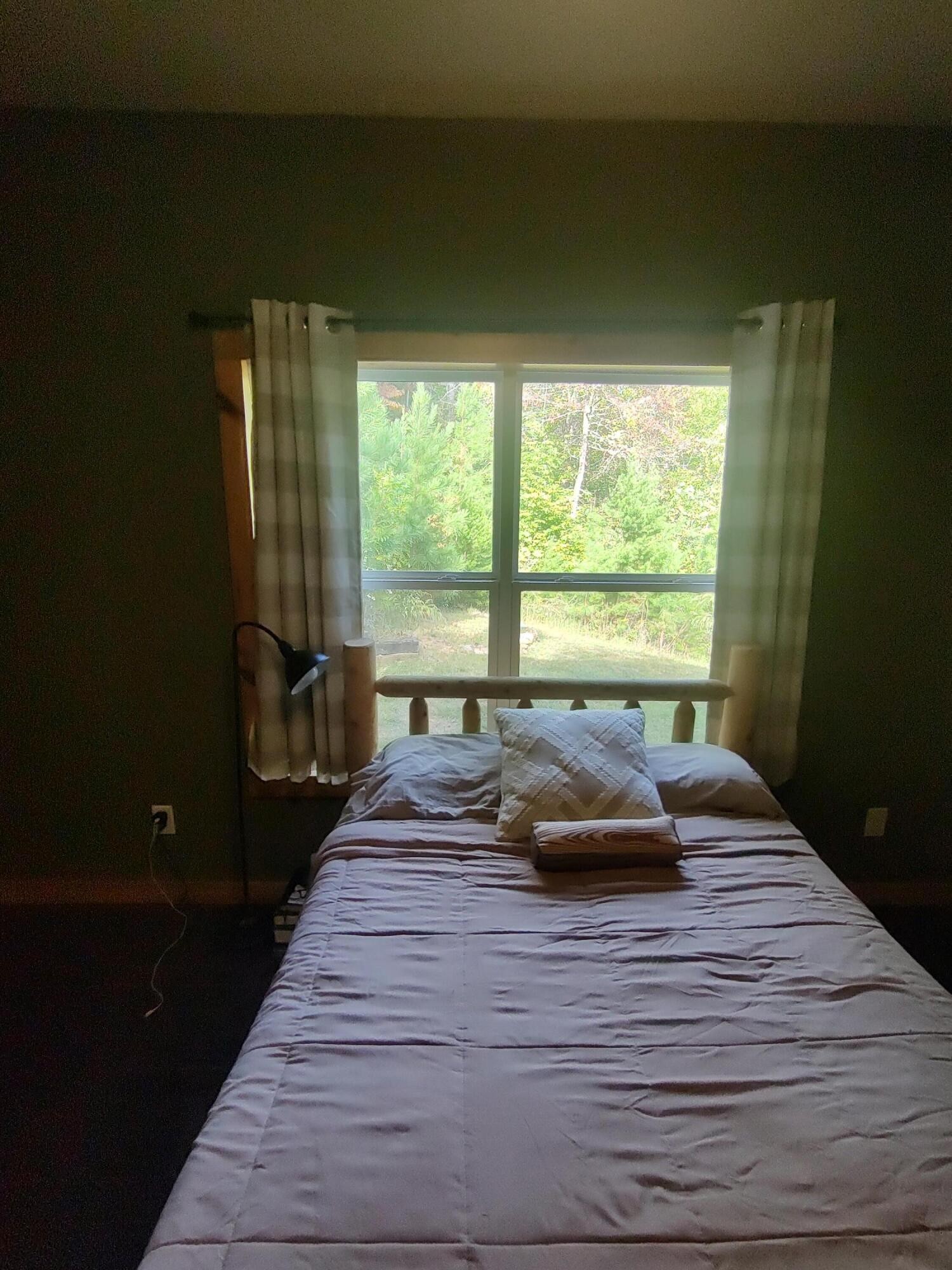 121 Polly Wally Road Ocoee, TN 37361 - Photo 16 of 29 a bed sitting in a bedroom next to a window