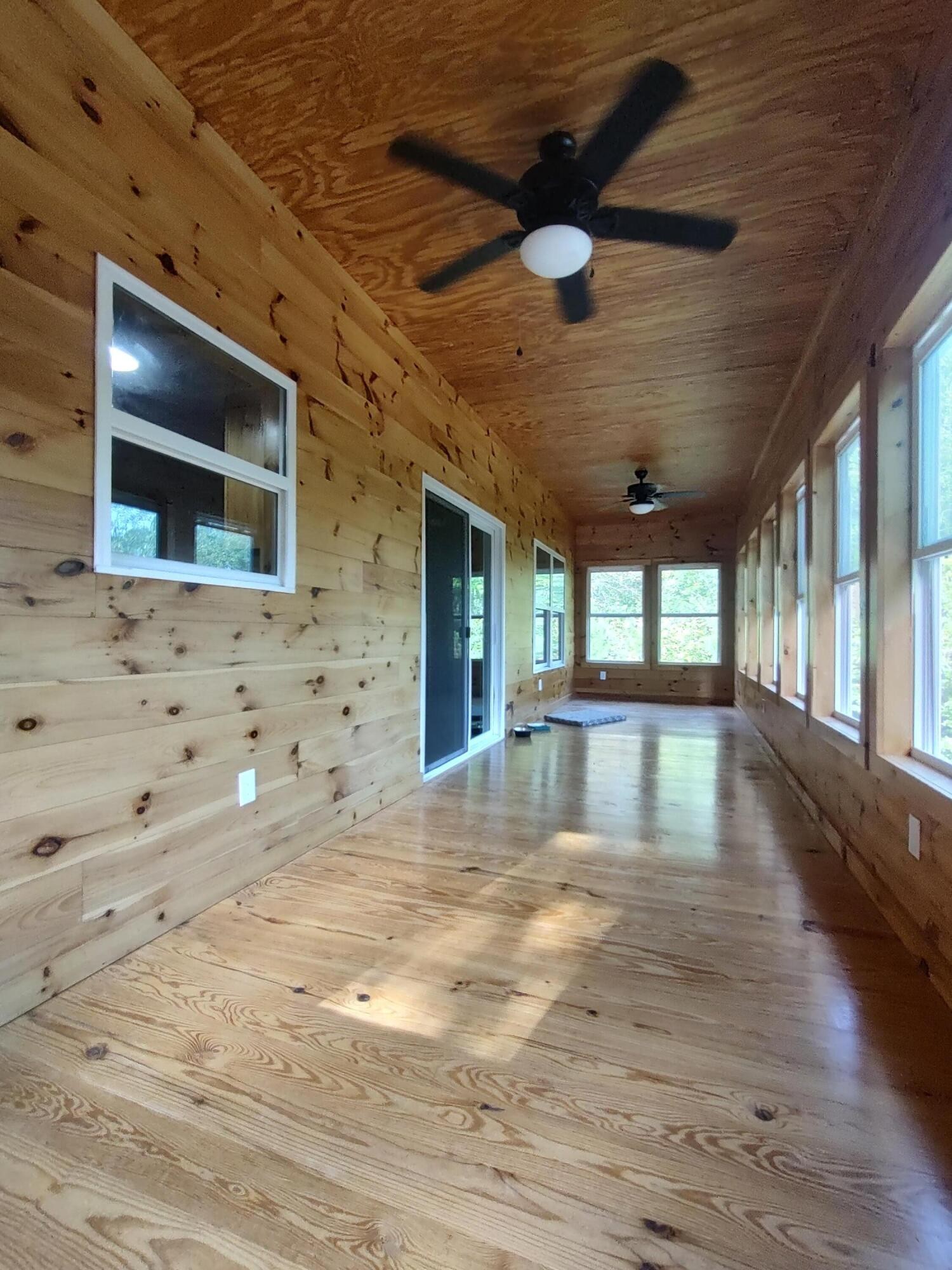 121 Polly Wally Road Ocoee, TN 37361 - Photo 20 of 29 a view of an empty room with wooden floor and a large window