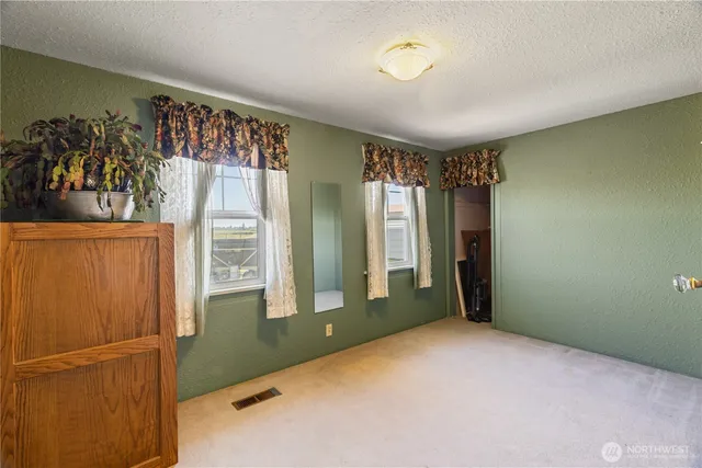 a view of a room with window and hardwood