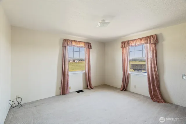an empty room with closet and a window