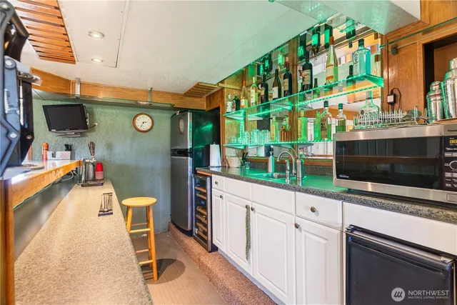 a kitchen with stainless steel appliances kitchen island granite countertop a sink and cabinets