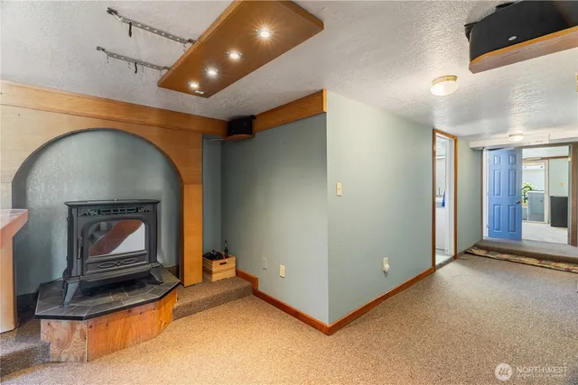 a living room with fireplace furniture and a ceiling fan