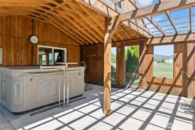 a view of a porch with wooden floor and furniture