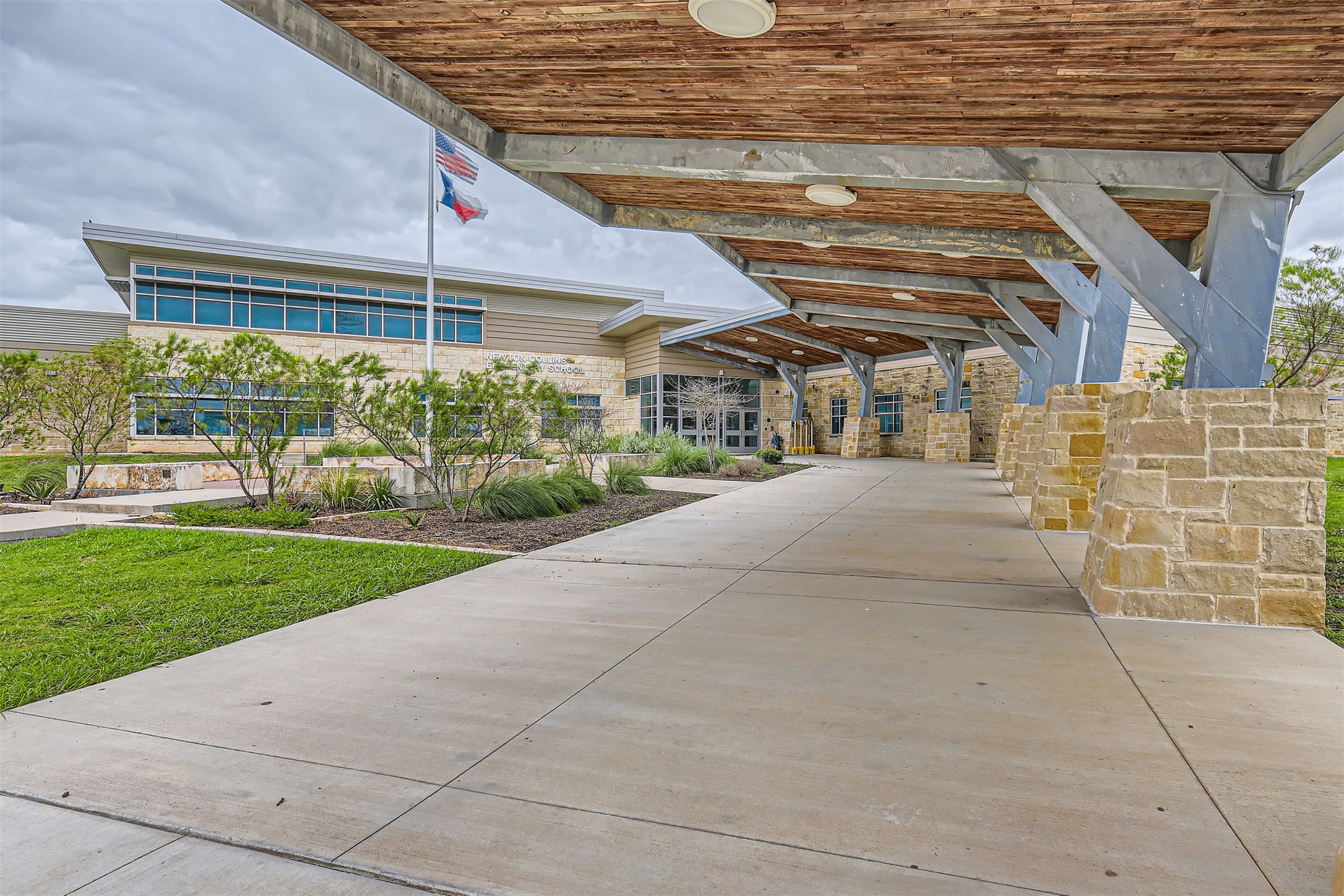 8313 Spire View Austin, TX 78744 - Photo 32 of 33 A well-maintained facade with stone accents and a covered walkway creates a welcoming entry.