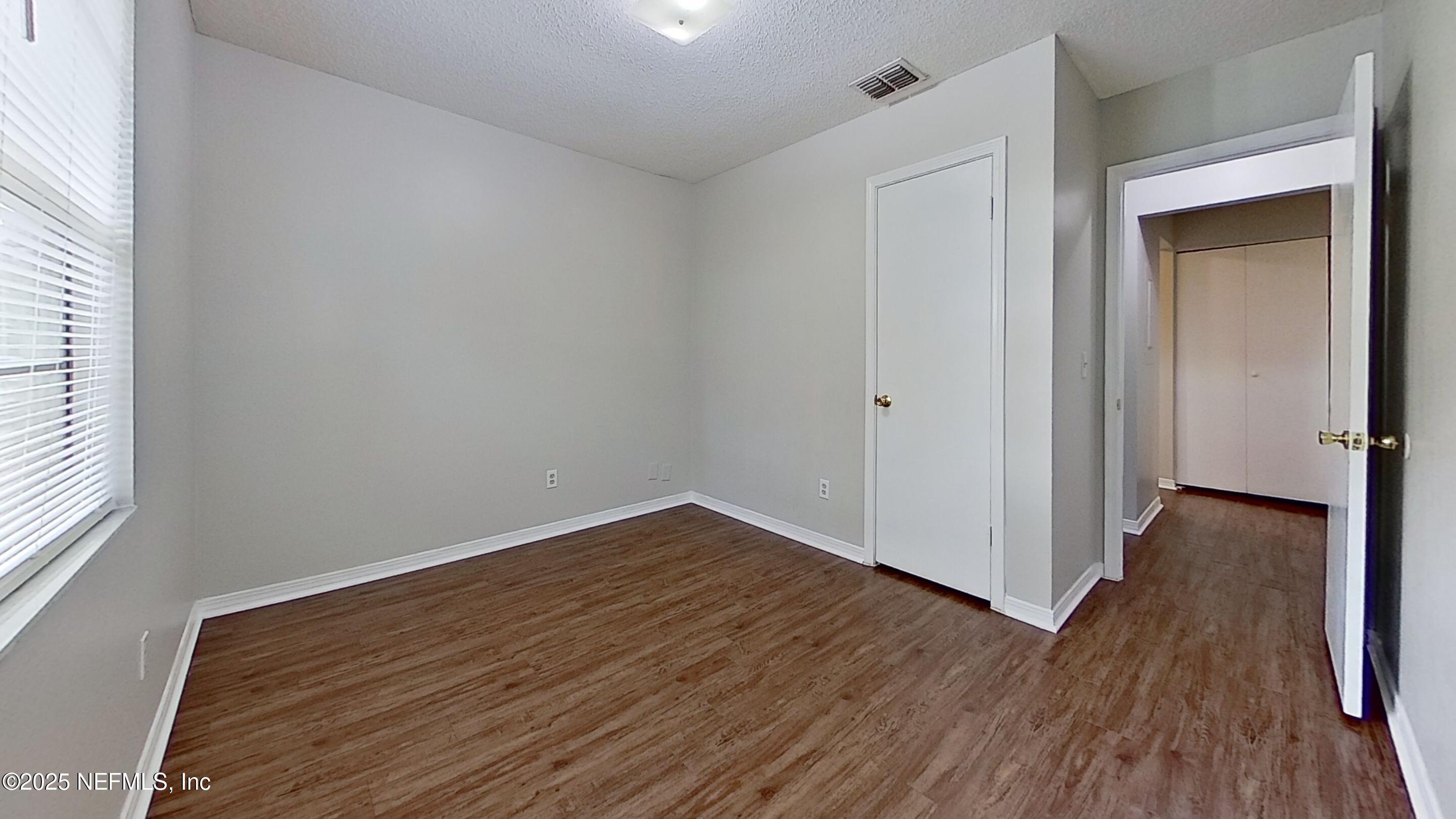477 Crabapple Court, Unit C Orange Park, FL 32073 - Photo 11 of 13 a view of a room with wooden floor