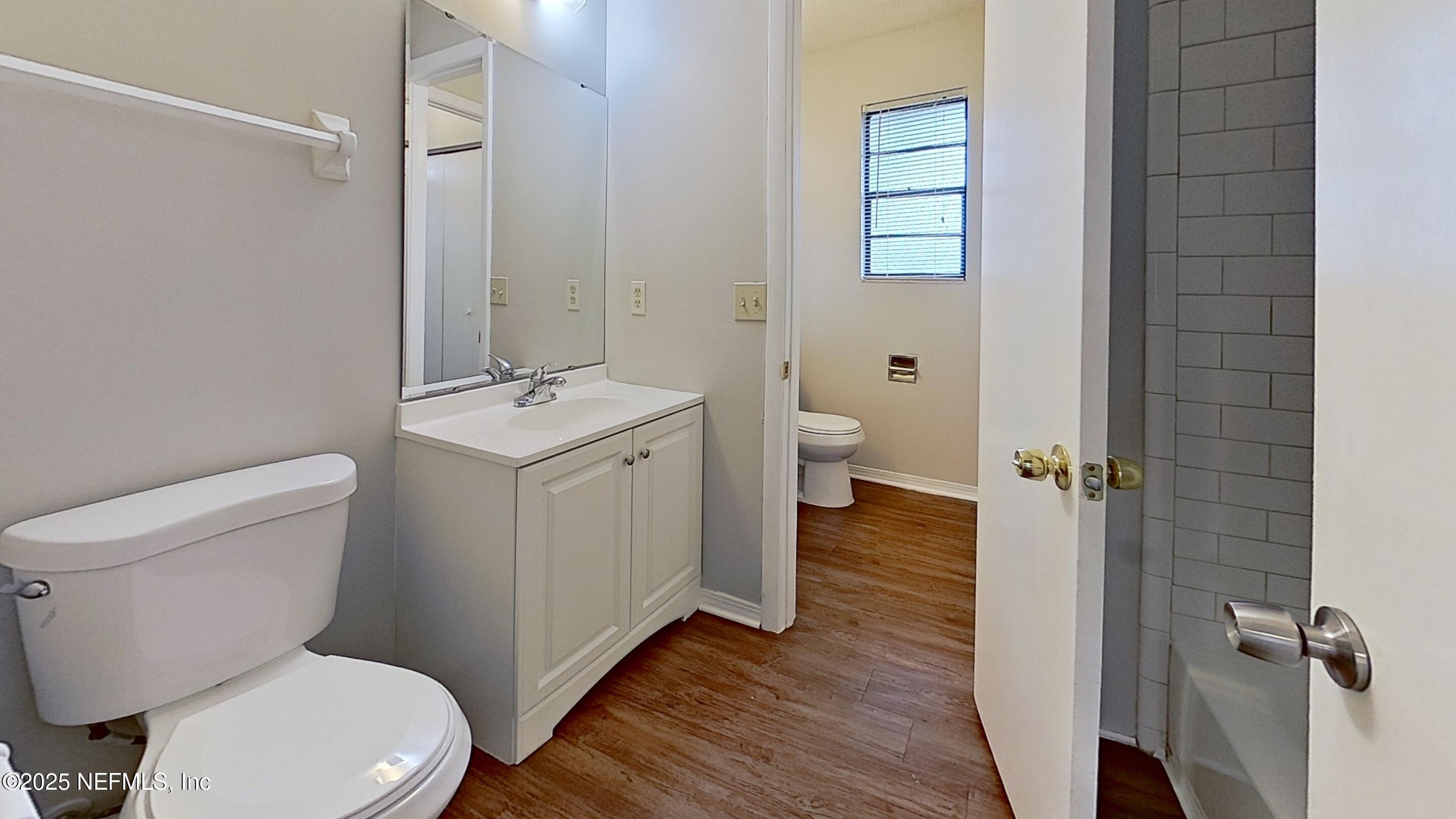 477 Crabapple Court, Unit C Orange Park, FL 32073 - Photo 5 of 13 a white toilet sitting next to a bathroom sink