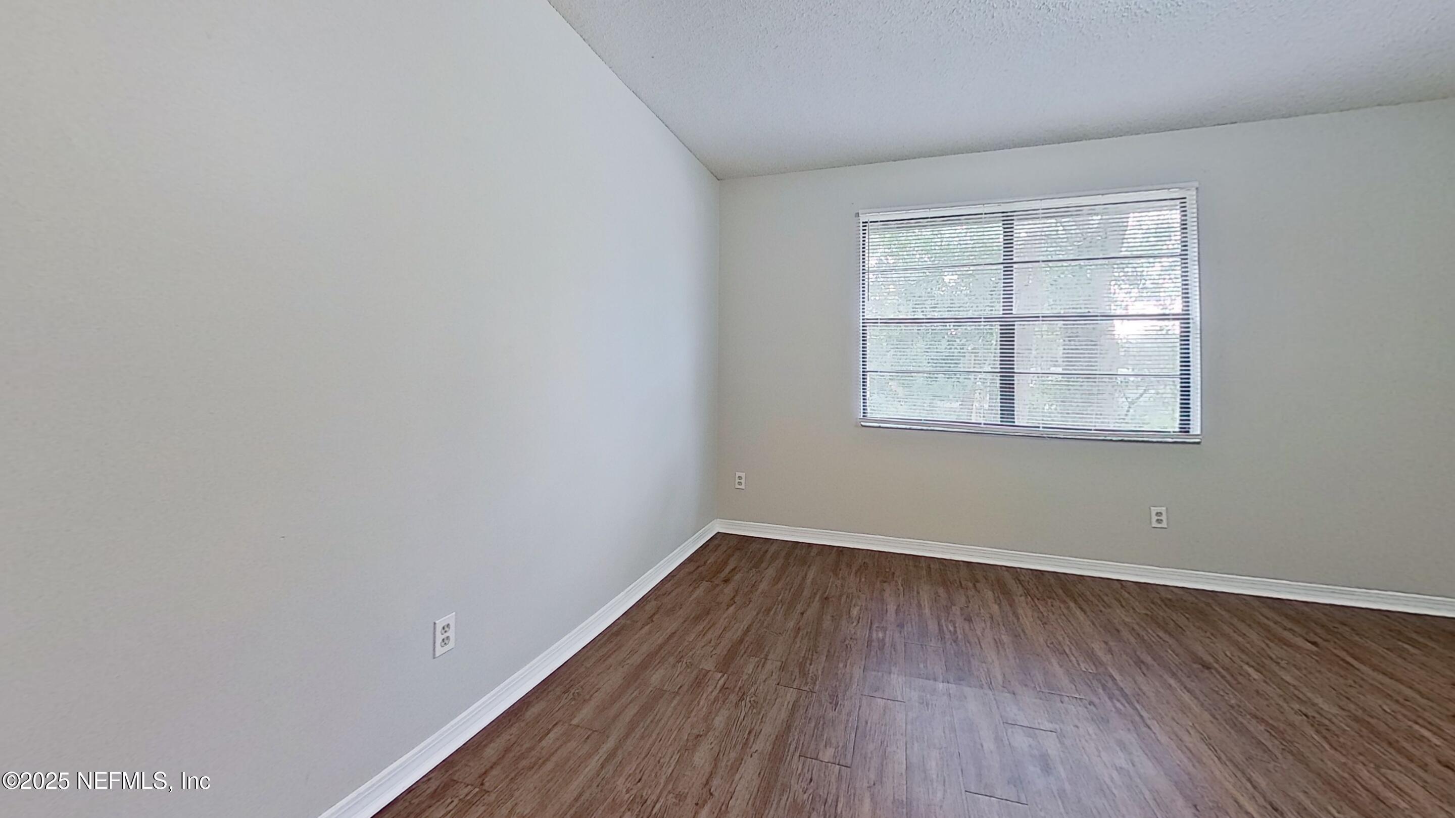 477 Crabapple Court, Unit C Orange Park, FL 32073 - Photo 9 of 13 wooden floor in an empty room with a window