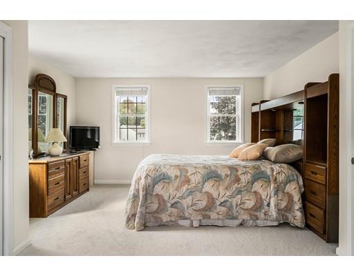 48 Rainbow Drive Haverhill, MA 01835 - Photo 16 of 33 a large bed sitting in a bedroom next to a window with dresser