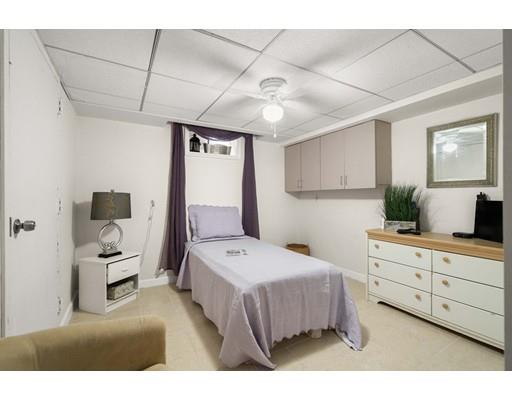 48 Rainbow Drive Haverhill, MA 01835 - Photo 26 of 33 a bedroom with a bed and a chandelier