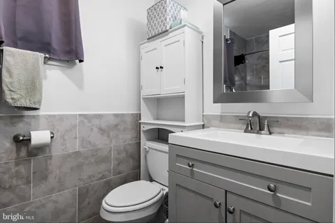 a bathroom with a sink a toilet and a mirror