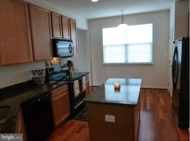 81 Glenbrook Road Ranson, WV 25438 - Photo 11 of 30 a kitchen with a sink a window appliances and cabinets